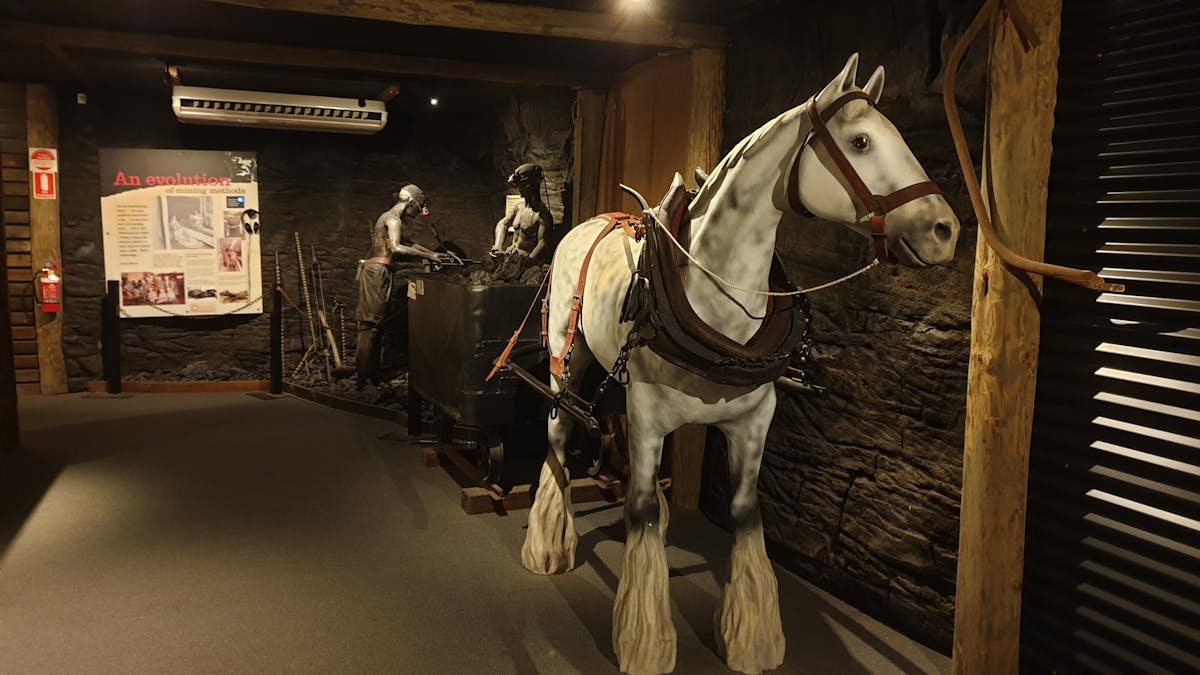 Statue of horse and two miners loading coal into carriage