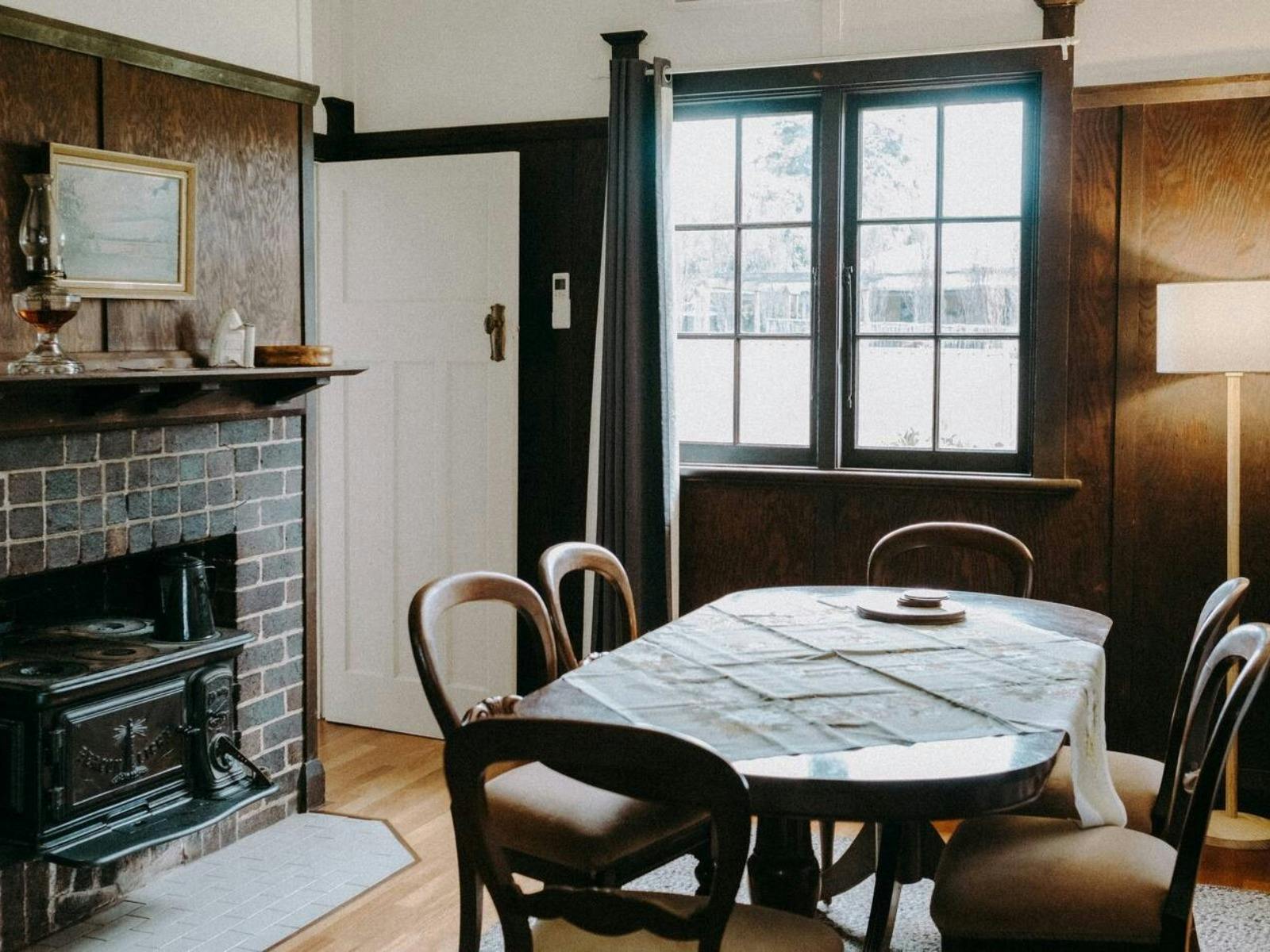 Dining beside fireplace at The Brown House Tenterfield
