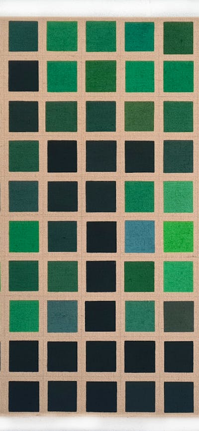 A painting depicting a grid of different shades of green squares on an unprimed canvas