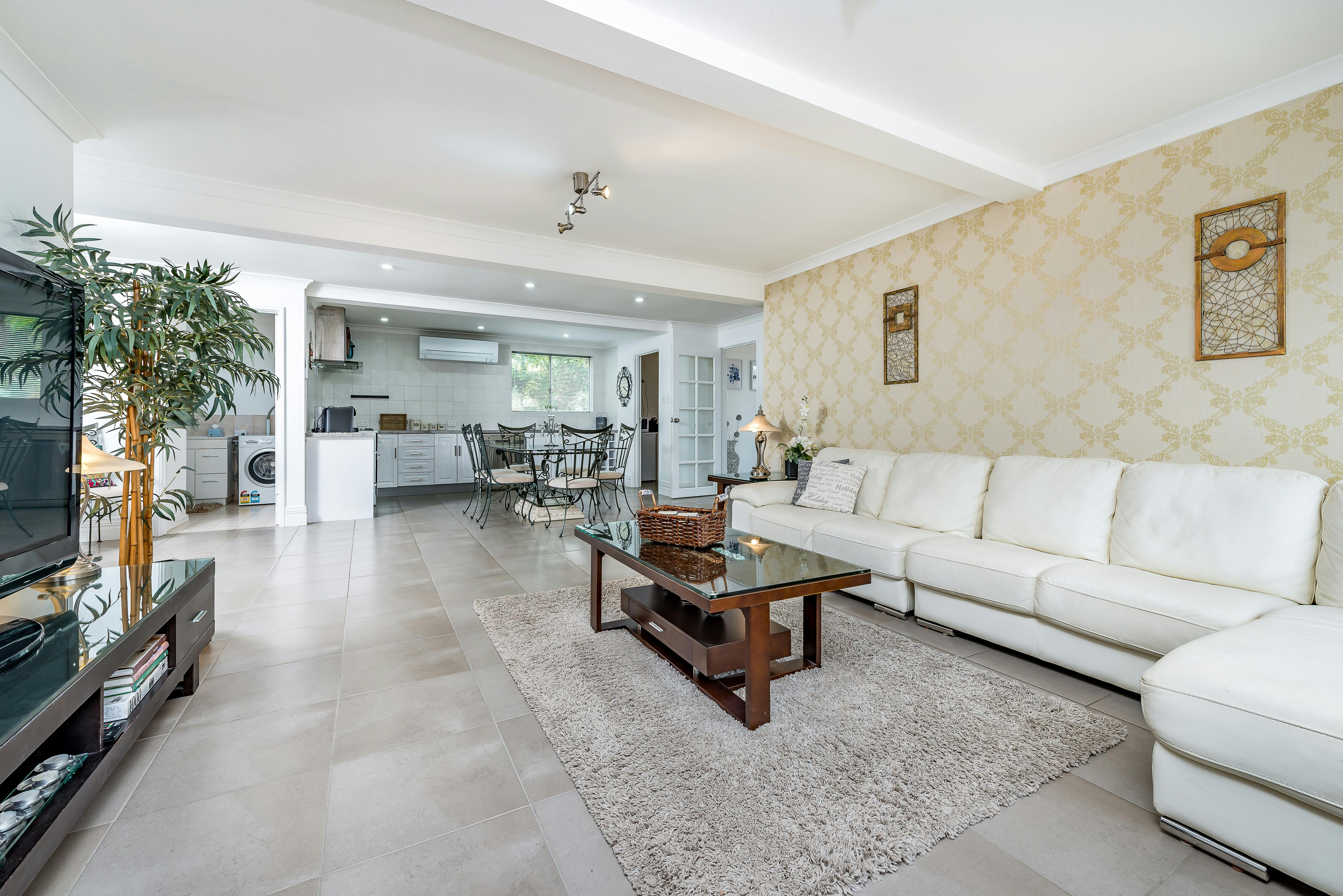 Open plan lounge area with large TV and quality furnishings