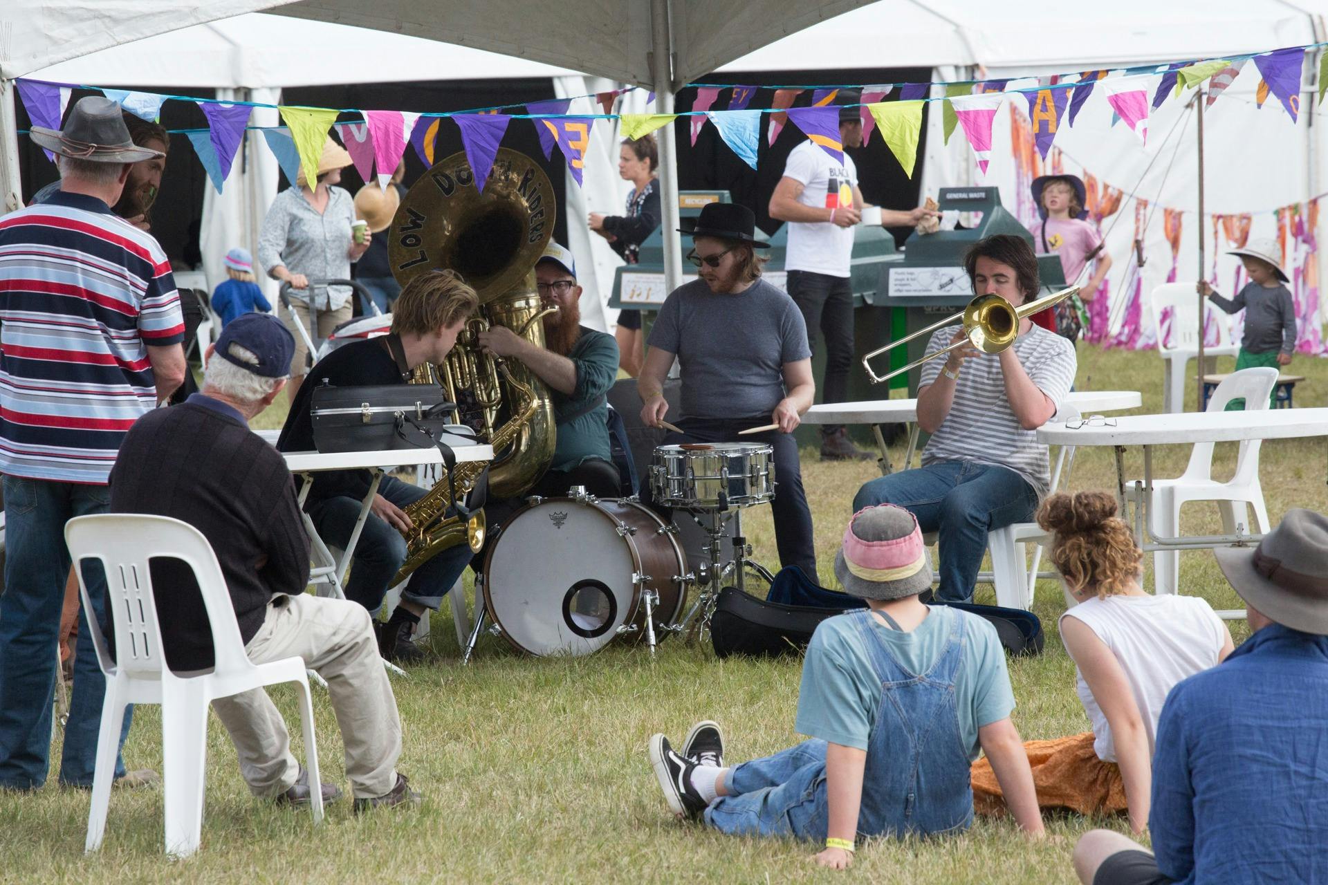 Sitting around band jamming on grass