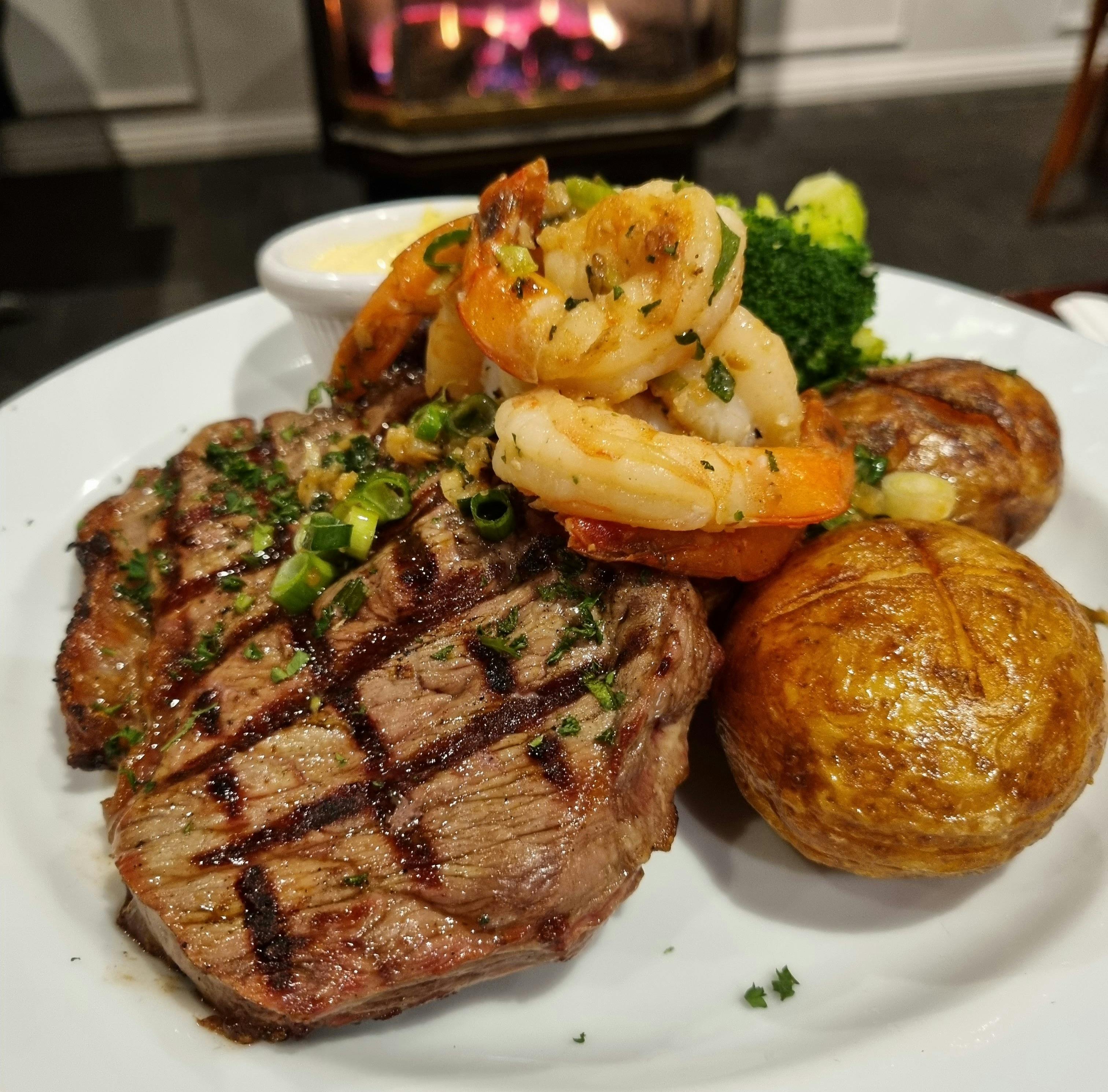 A 300gm Scotch Fillet topped with sauteed prawns, vegetables and a garlic cream dipping sauce
