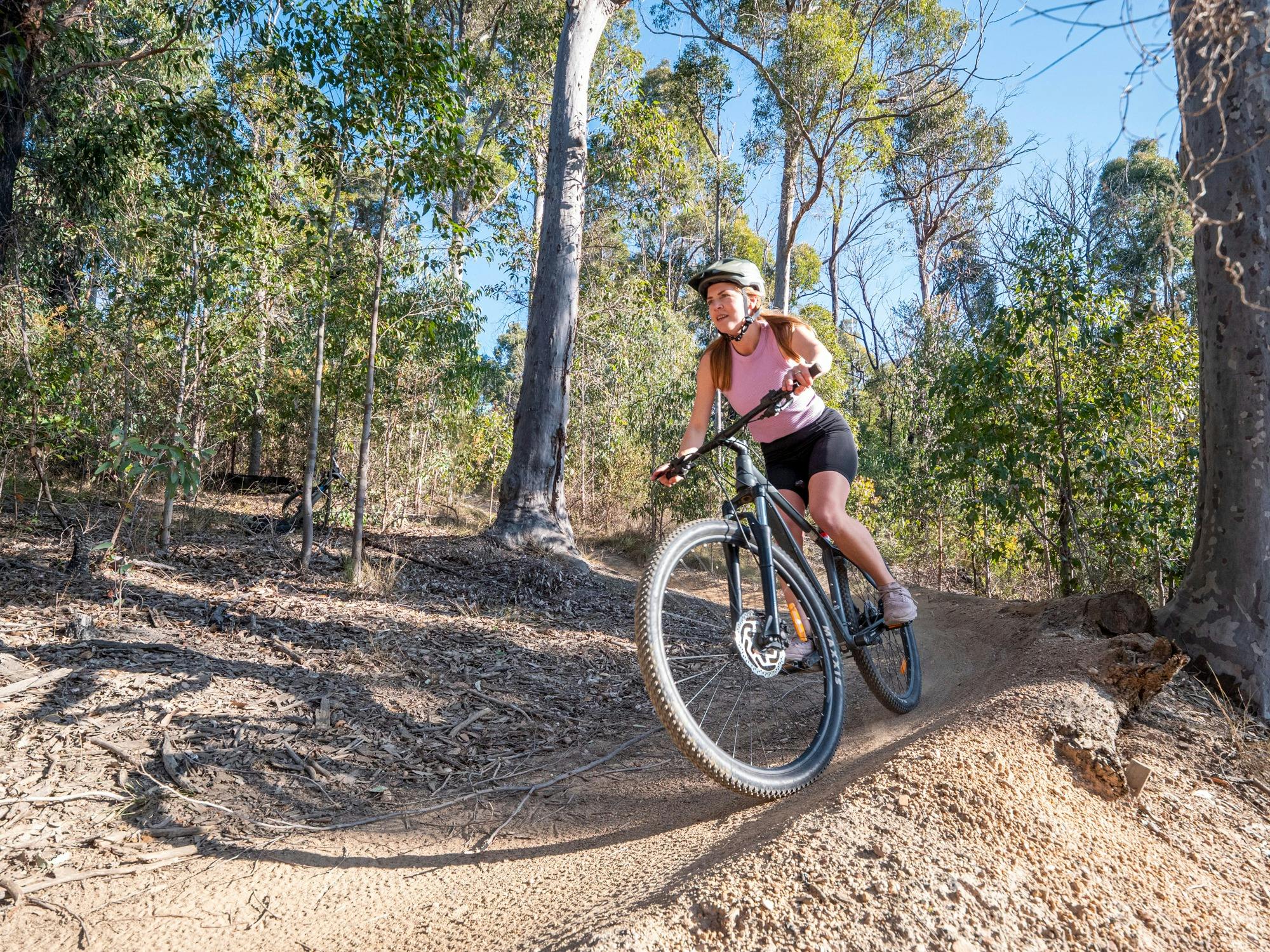 Female Mountain Biker entering a bend