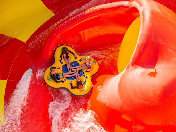 Four kids on red slide