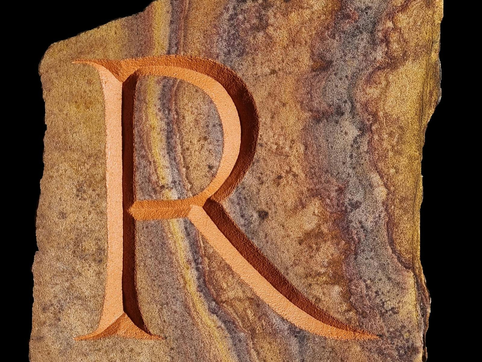 Letter R carved into stone