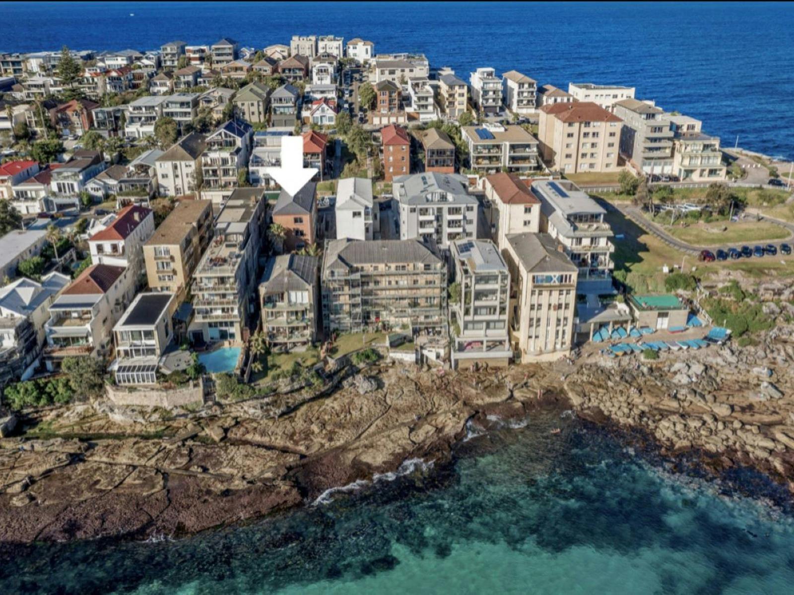 Aerial view of a property with breathtaking ocean and coastline views in a prime location.