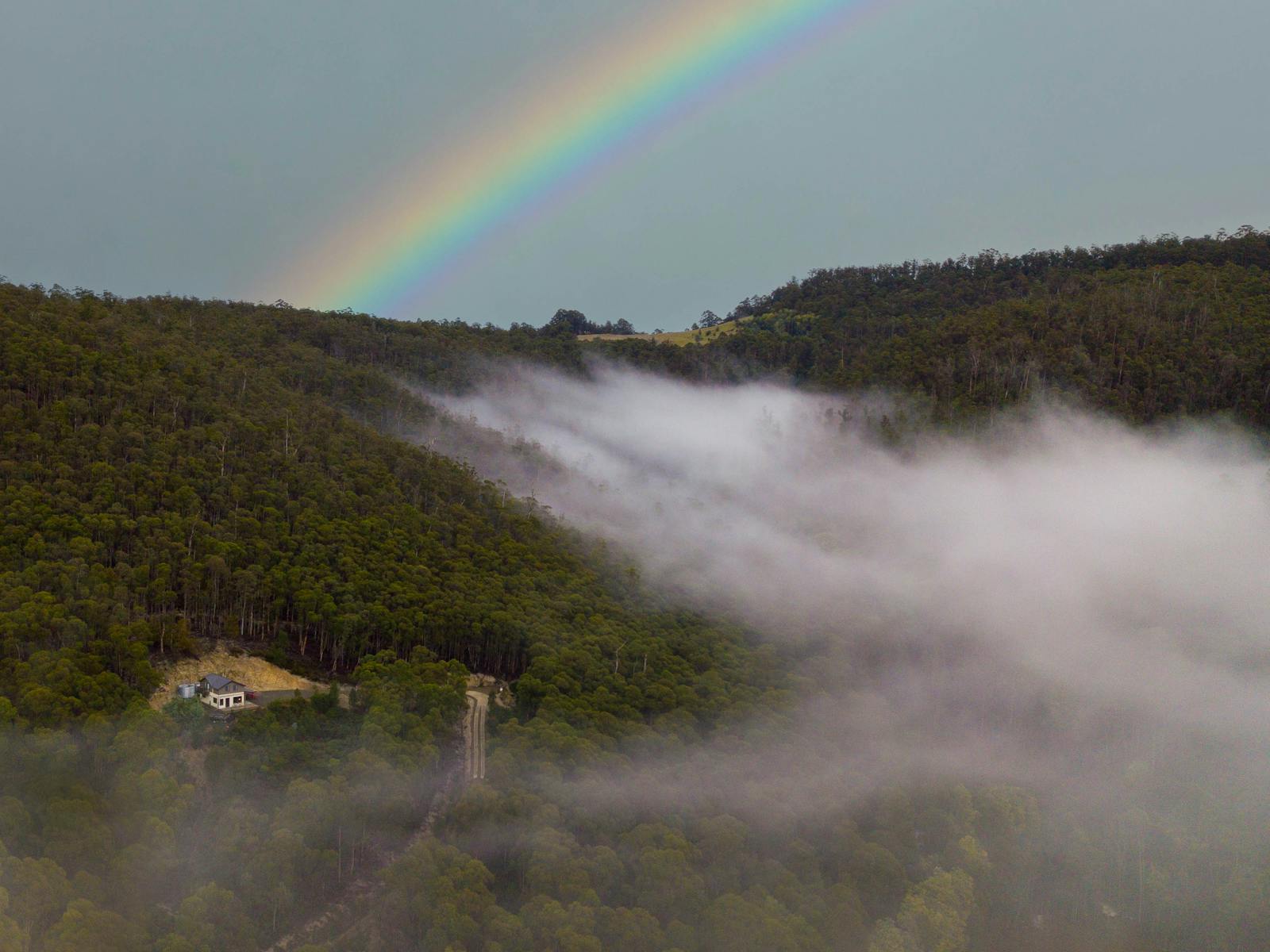 Rainbows and dreamy mists enveloping Orchards Nest hidden on the hillside