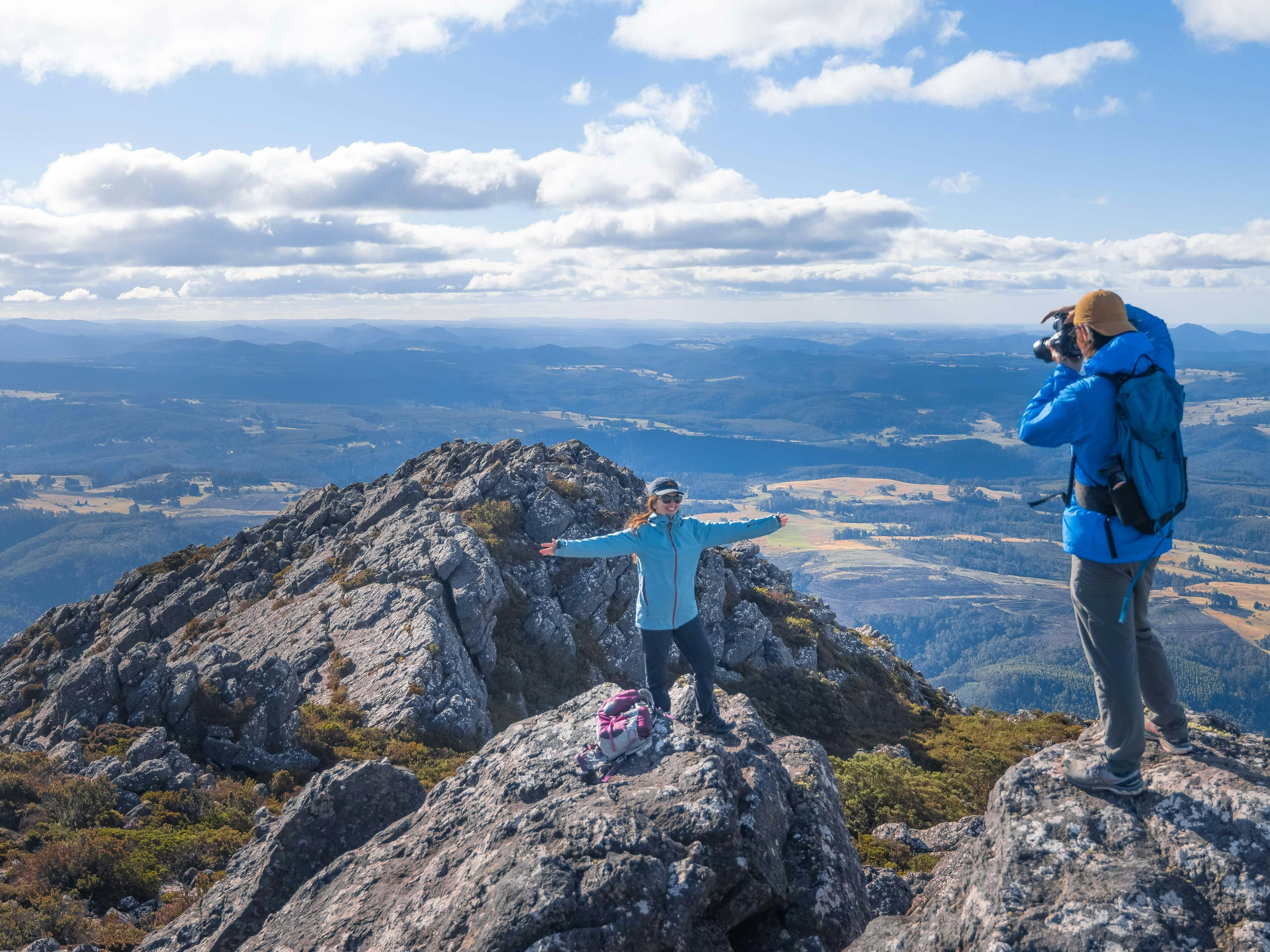 Hikers celebrate and commemorate reaching the peak