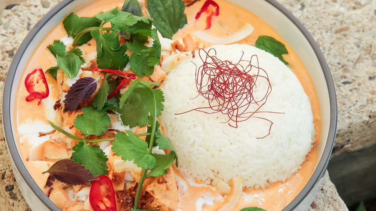 Slow-cooked beef cheeks yellow curry with coconut.