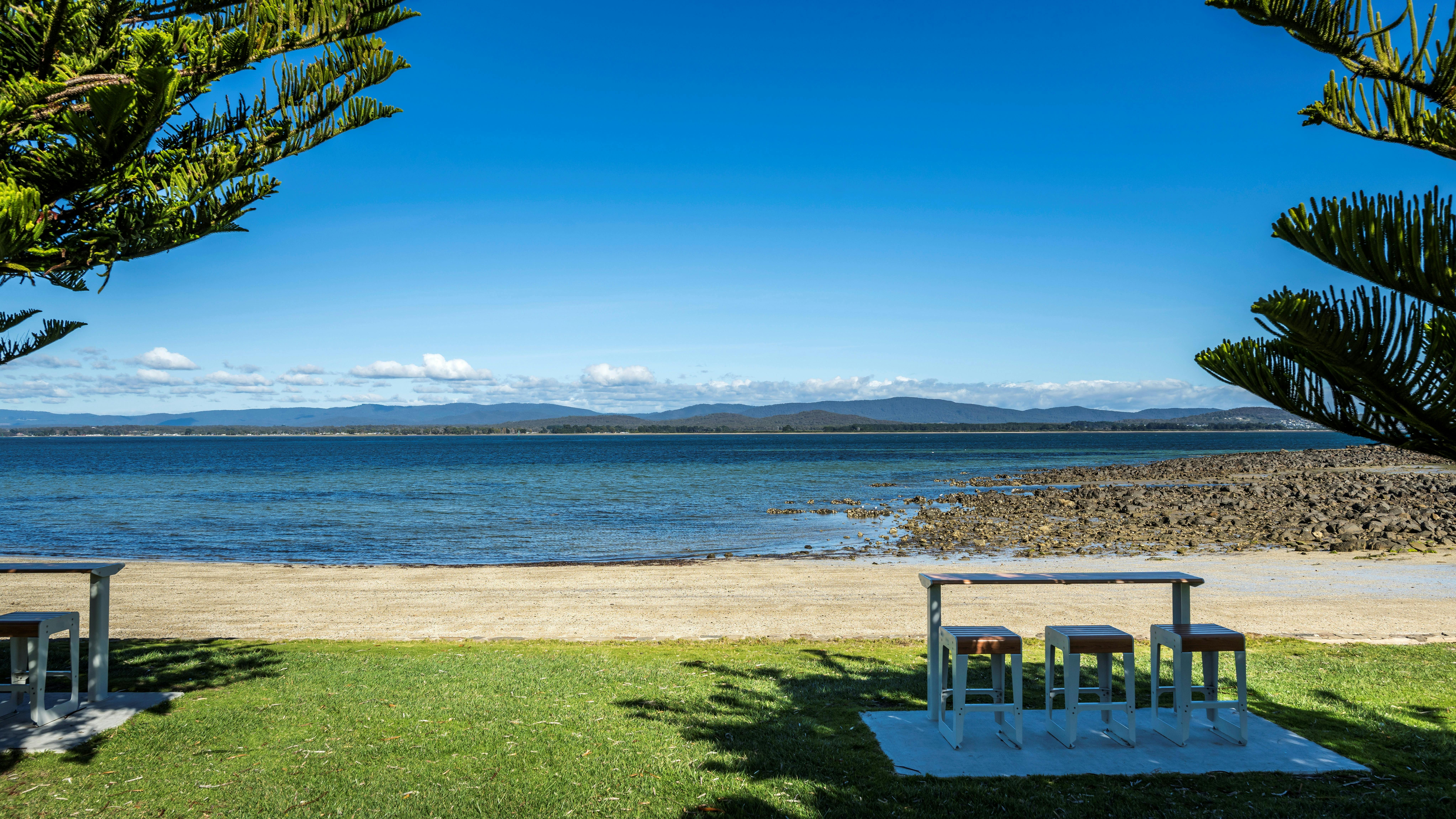 Bench seats looking out onto water at Lagoon Beach