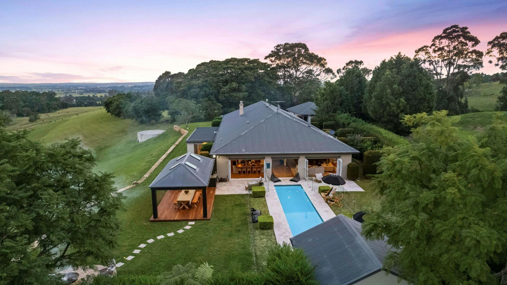 Image of aerial view of property looking over the back deck and pool area.