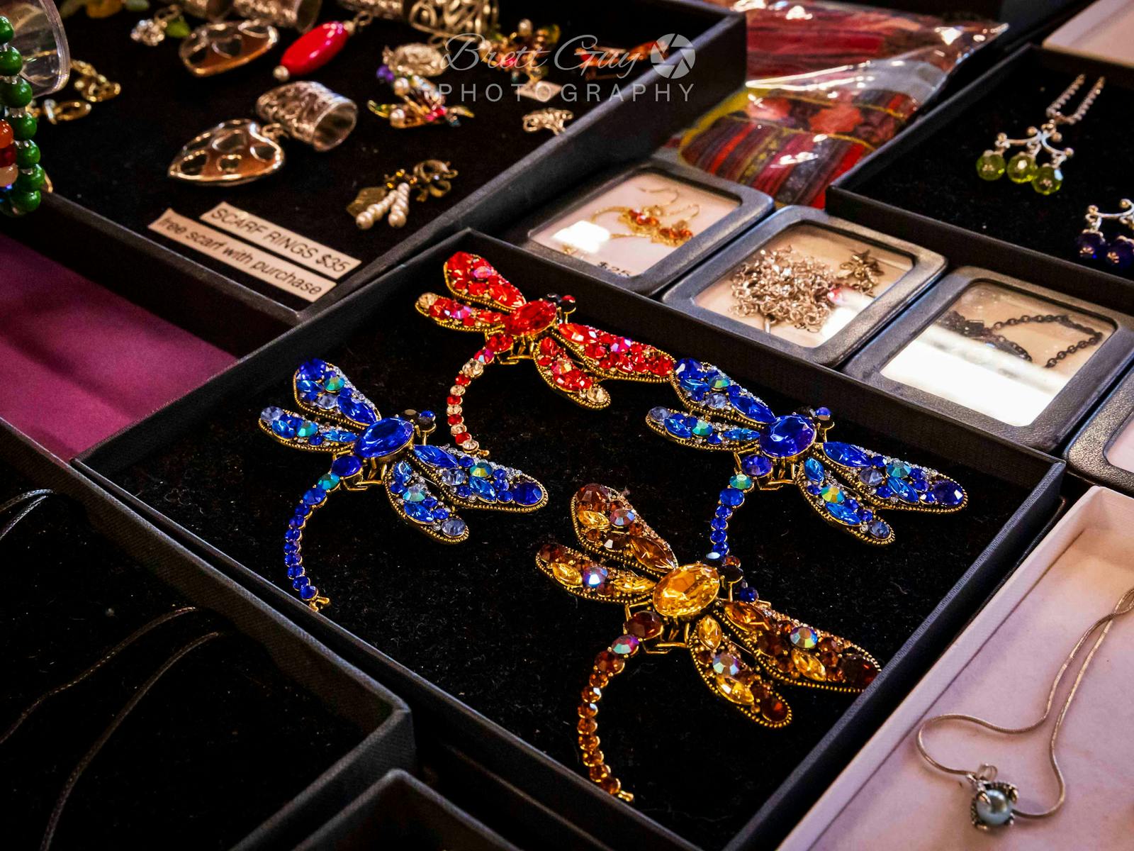 jewelled dragon brooches in a black display box