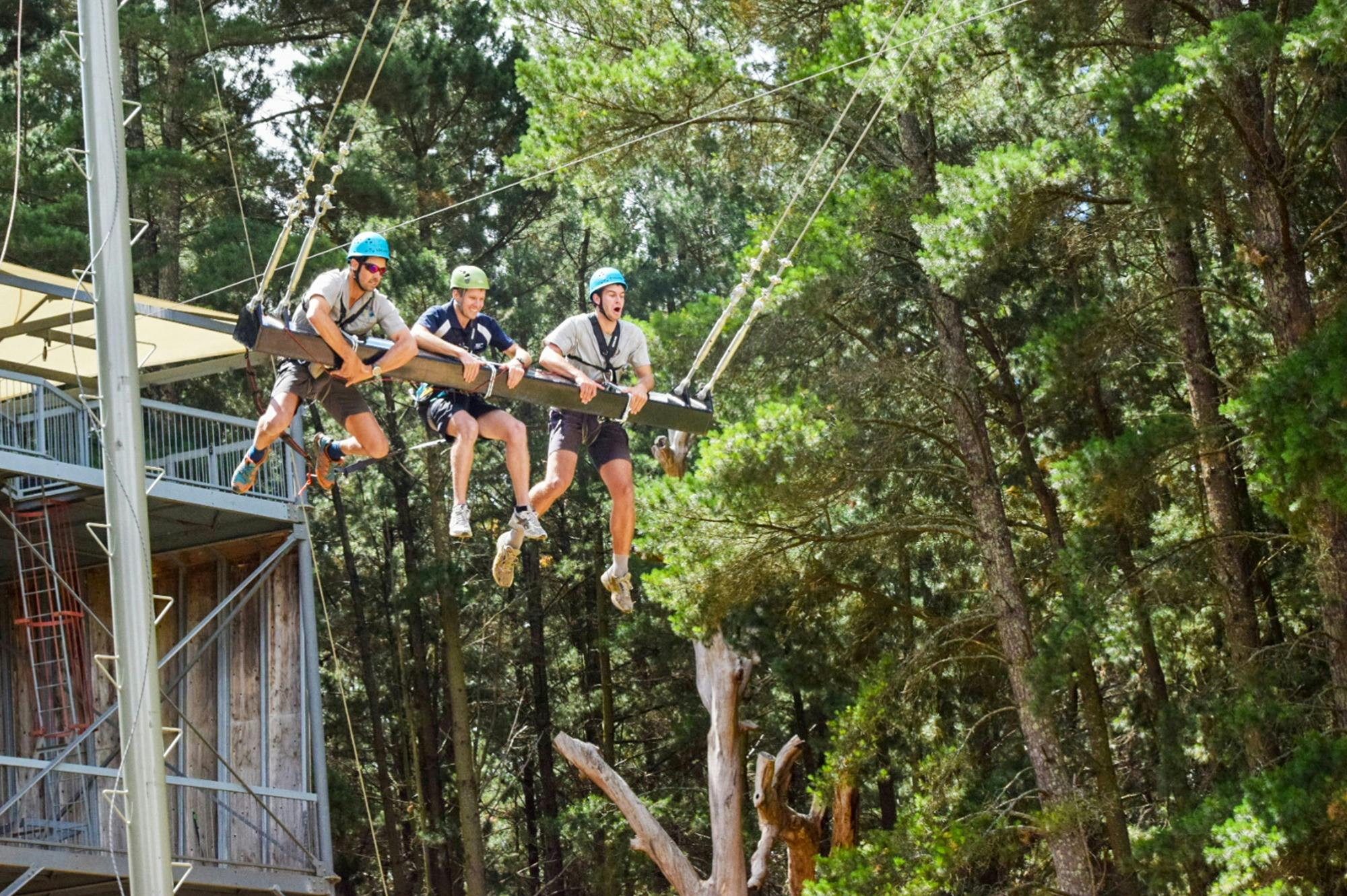 3 people on a mega swing mid air
