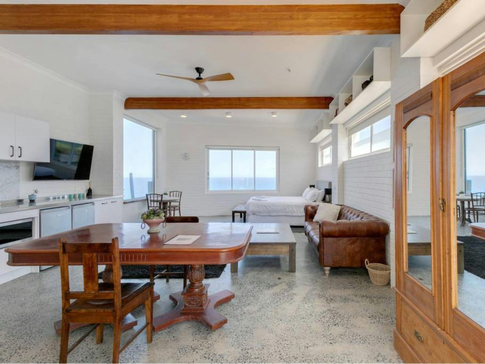 Open-plan living area with large windows showcasing stunning ocean views and natural light.