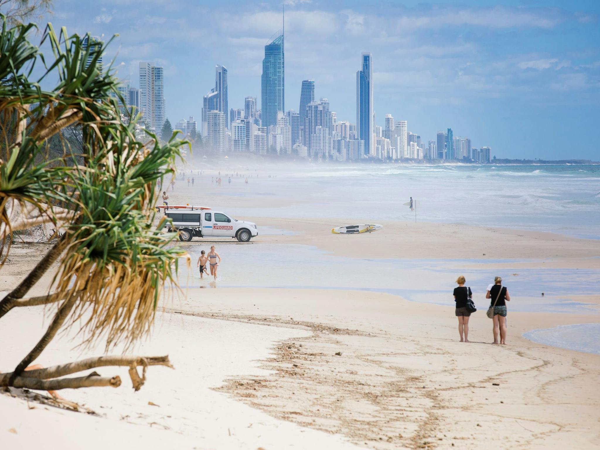 People walking along Nobby Beach People walking along Nobby Beach