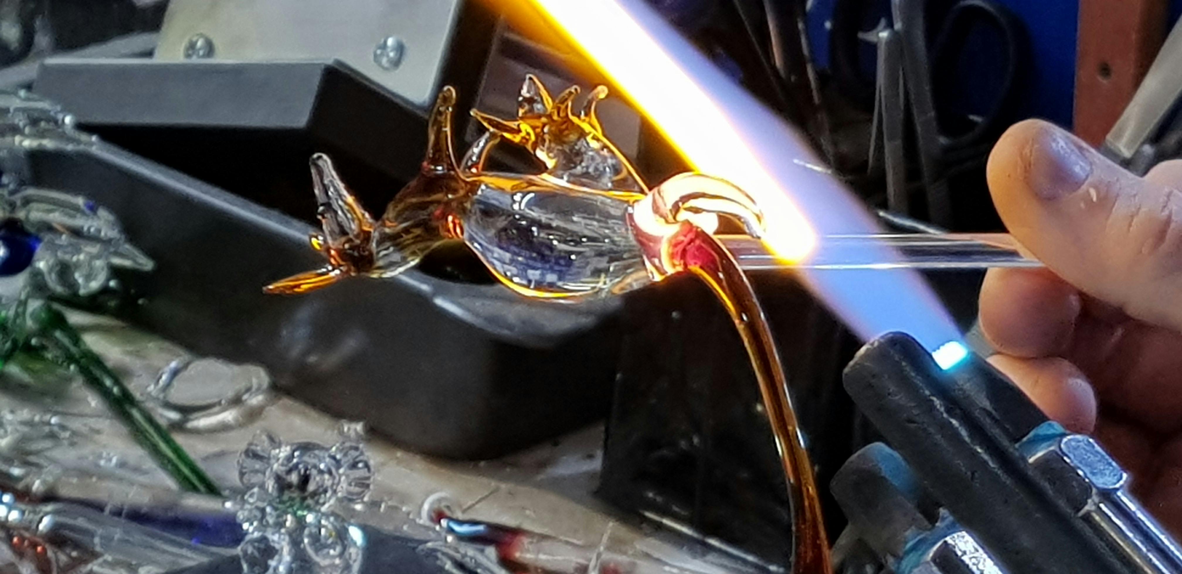 A Kangaroo with a little joey in her pouch with amber colour glass