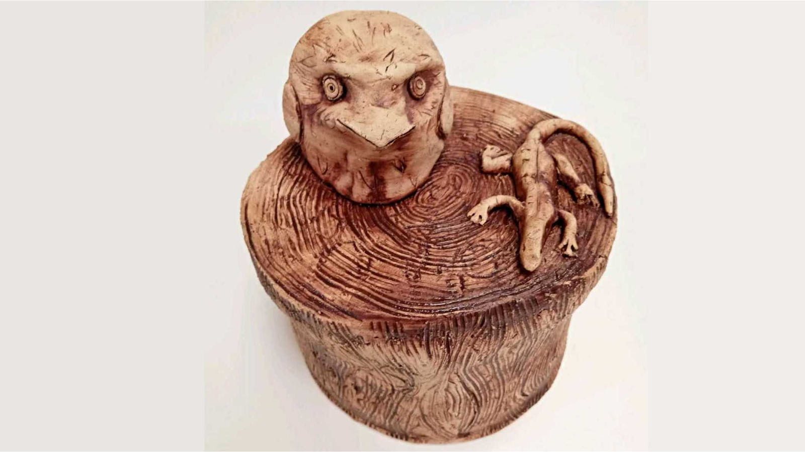 Owl and lizard on a post by Crystal