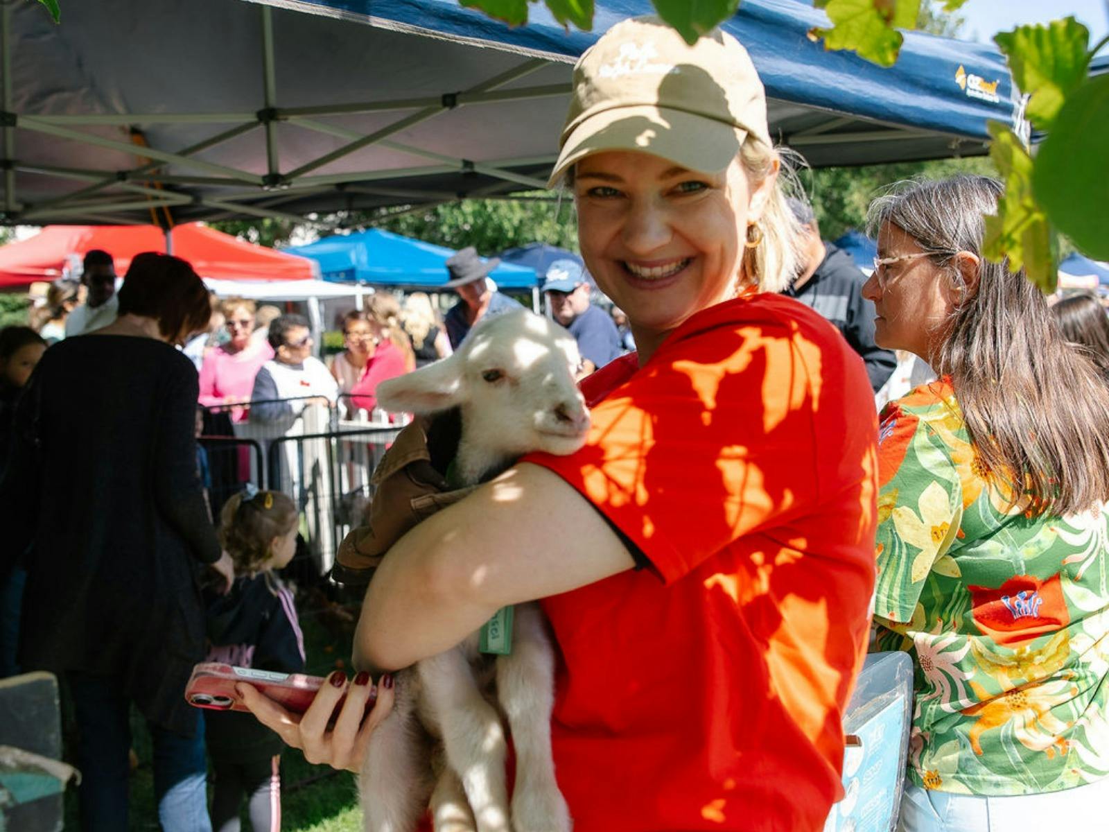 Volunteer holding one of the baby lambs