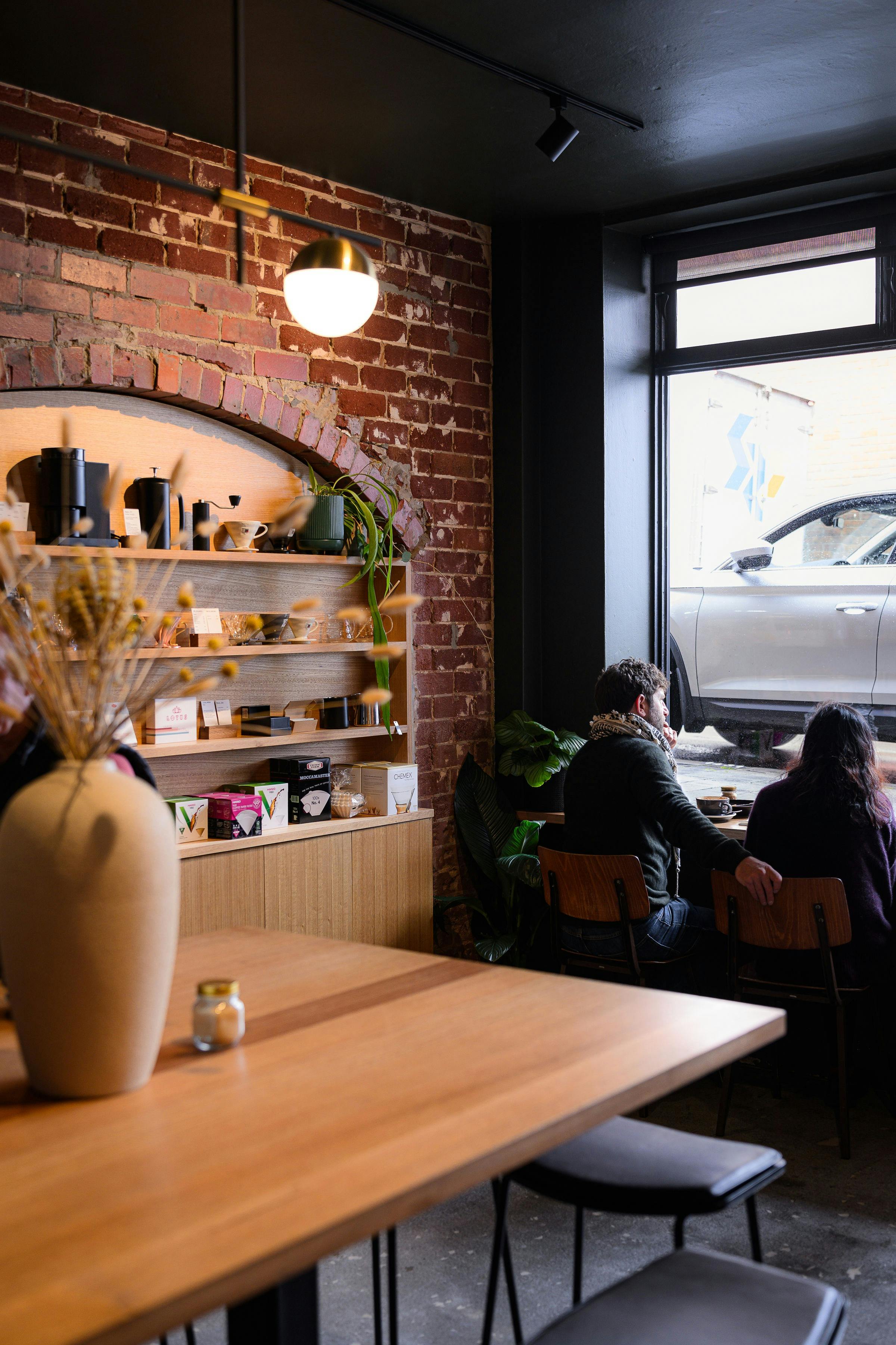 Window seating with retail shelf and long communal table