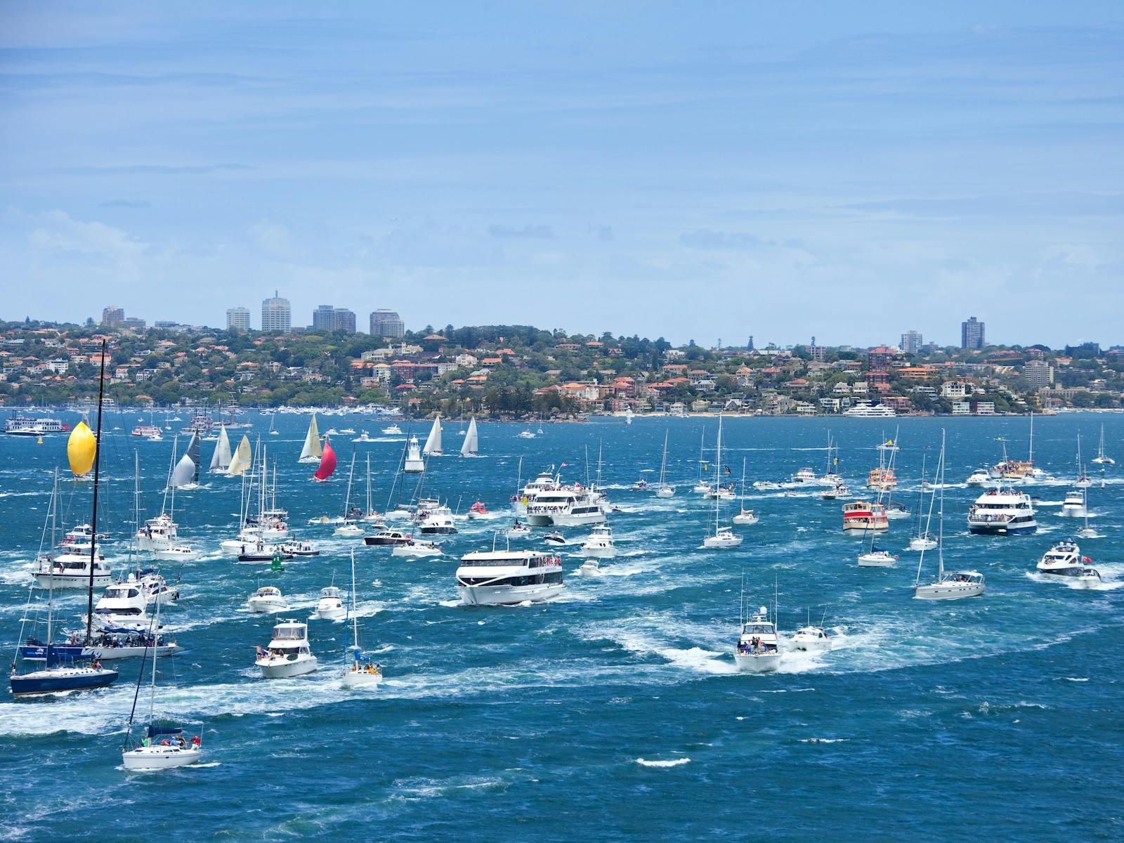 Yachts sailing in the Sydney to Hobart yacht race on Sydney Harbour