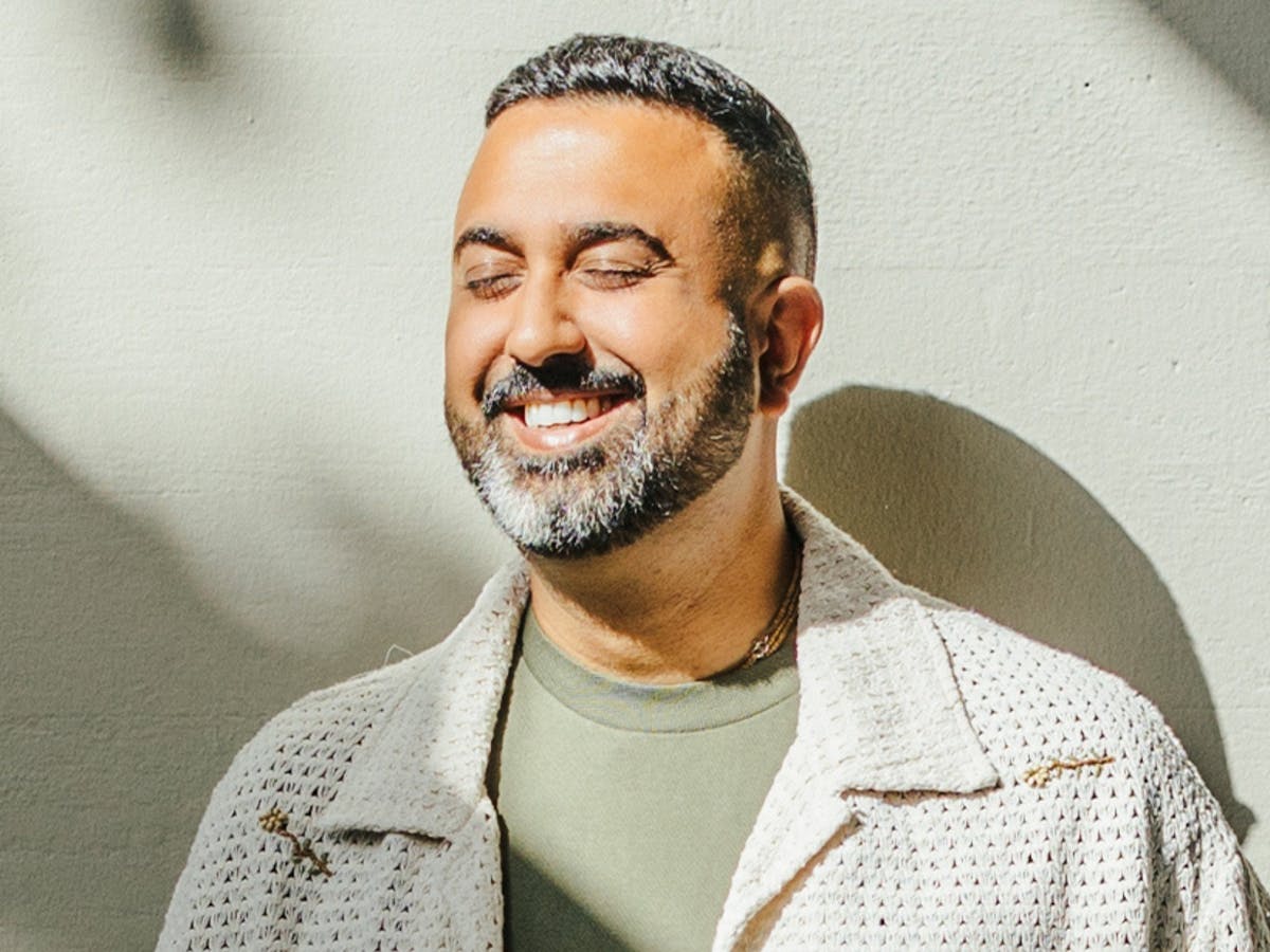 Male smiling with their eyes closed.