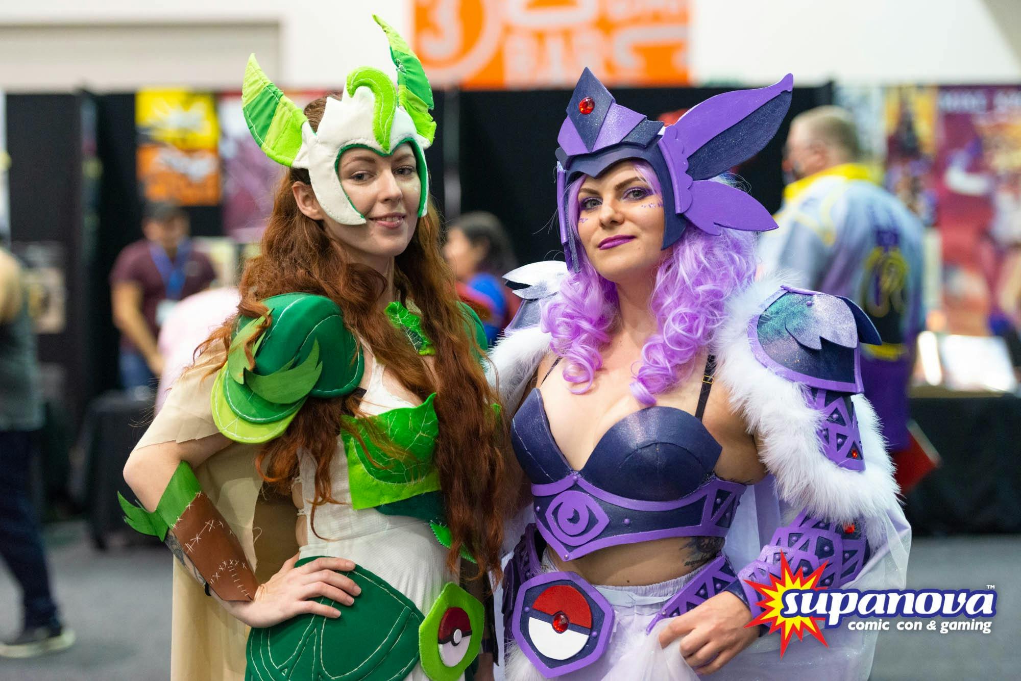Two girls in vibrant Pokémon cosplay striking a pose for a photo