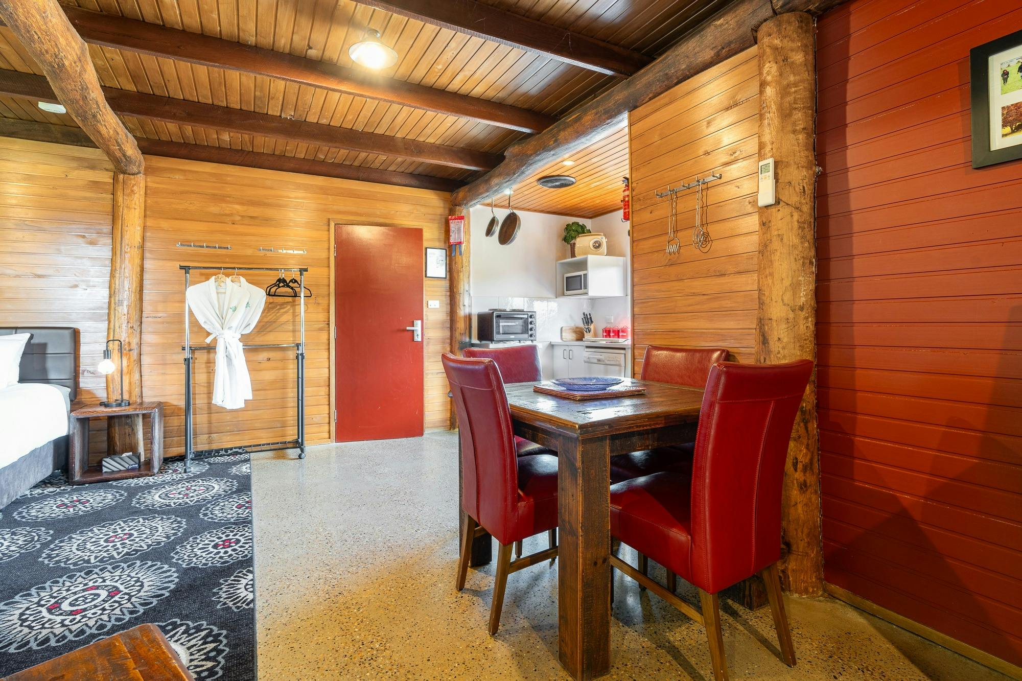 Cosy lodge with wood interiors, concrete floors and red features throughout.