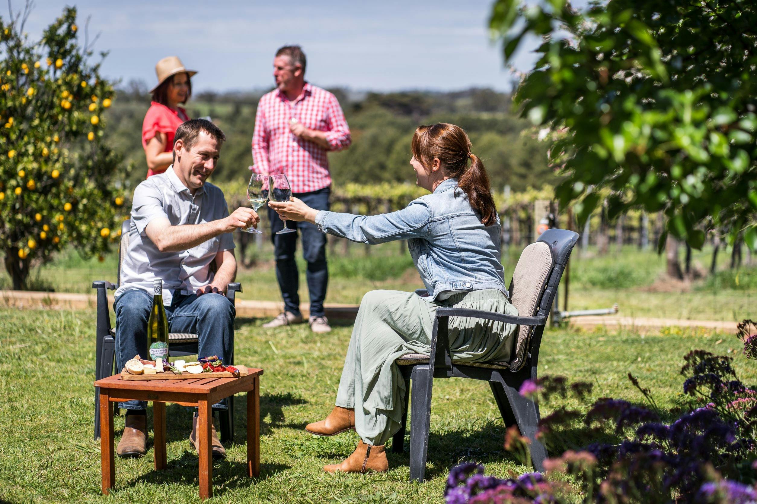 Guests seated in the garden with a wine tasting