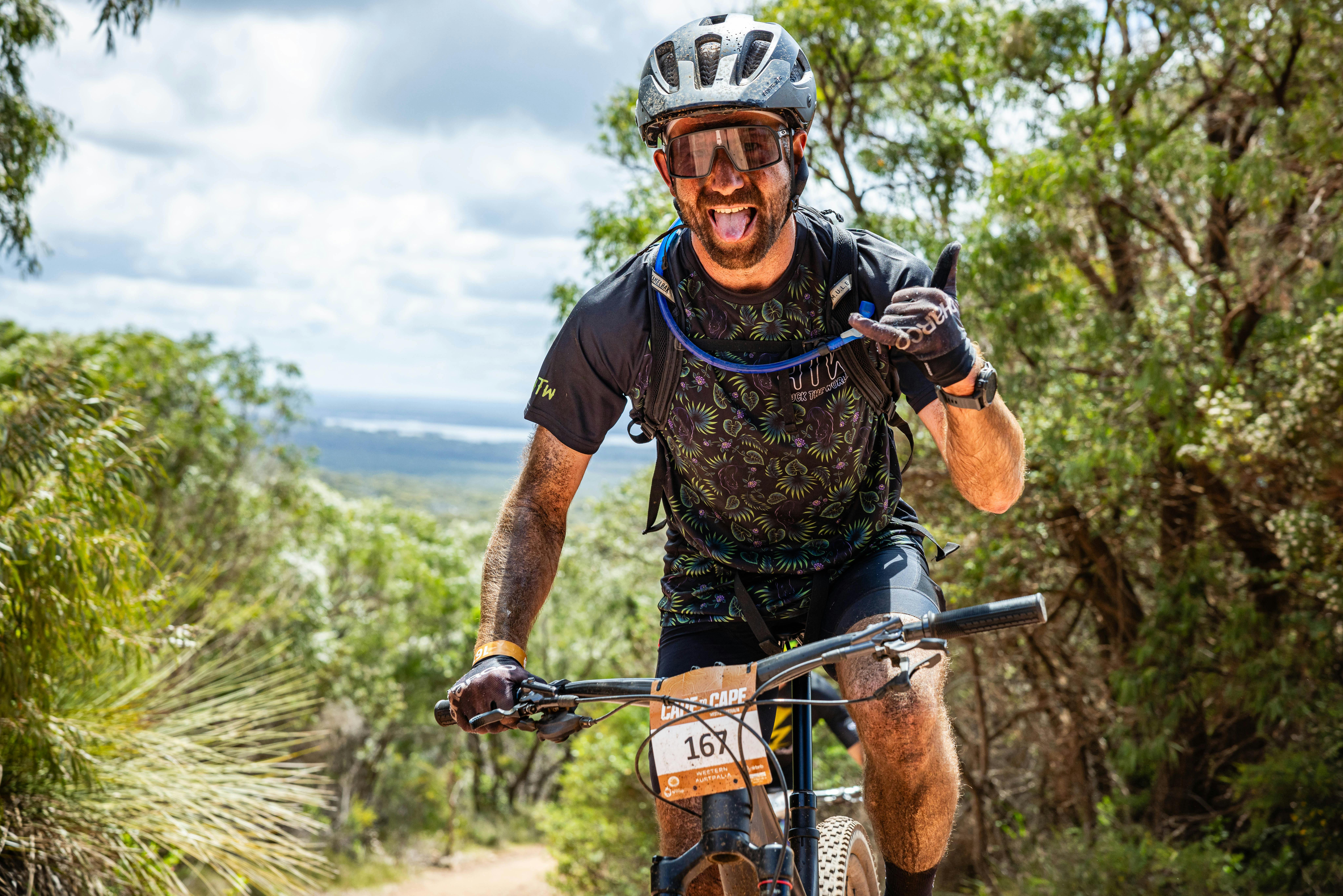 Male MTB Rider showing the Shaka hand sign.