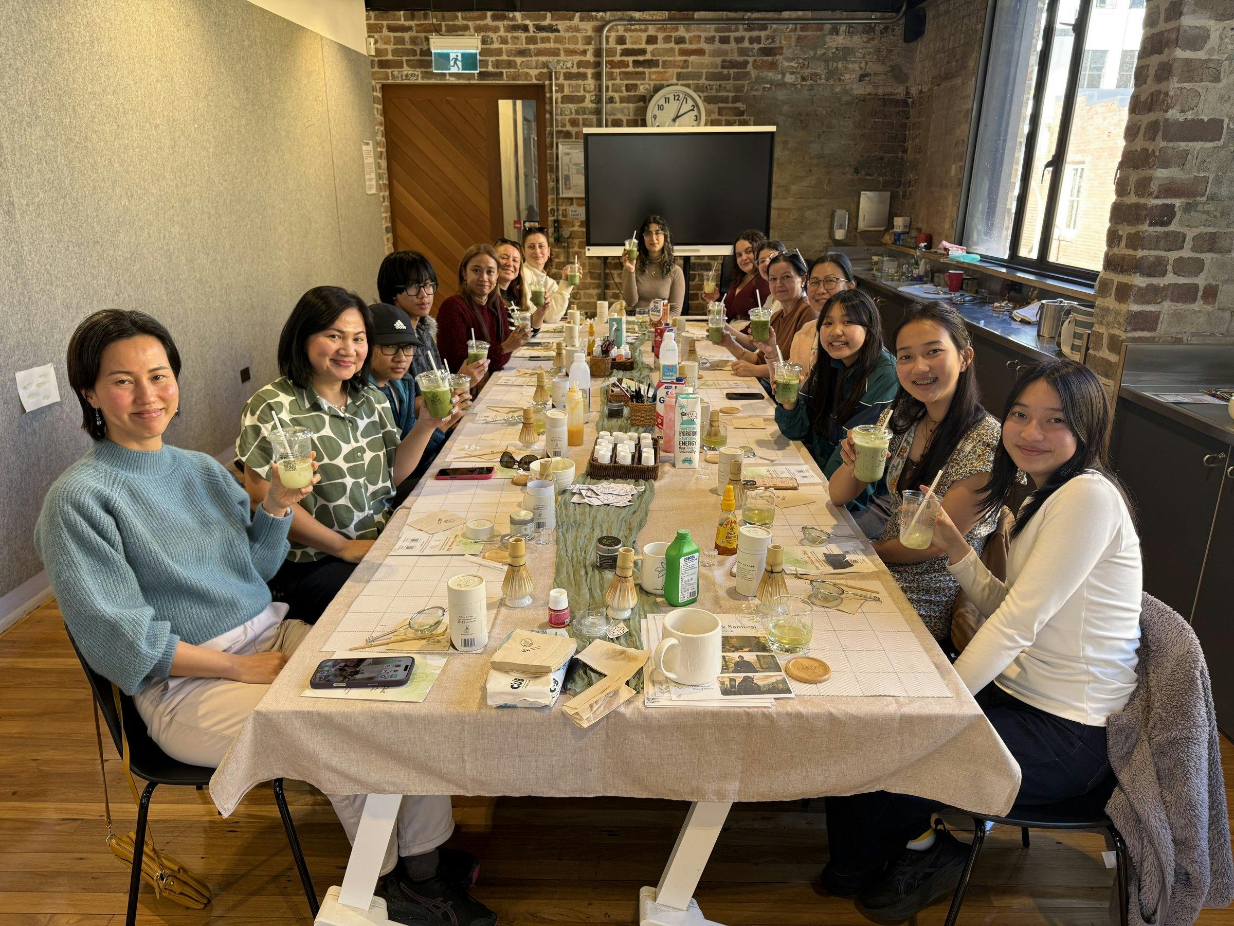 Group of guests at a long table during a NOA Matcha workshop