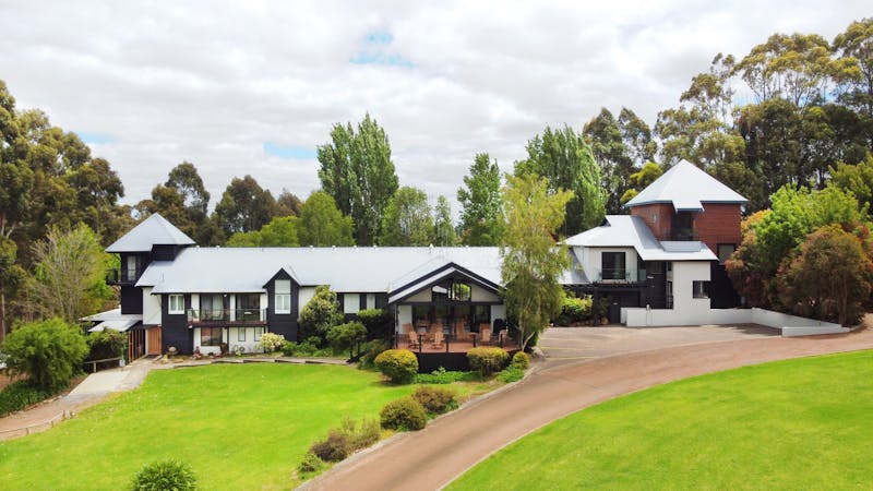 Chimes Spa Retreat, Beautiful black and white lodge-style building overlooking the Southern Ocean