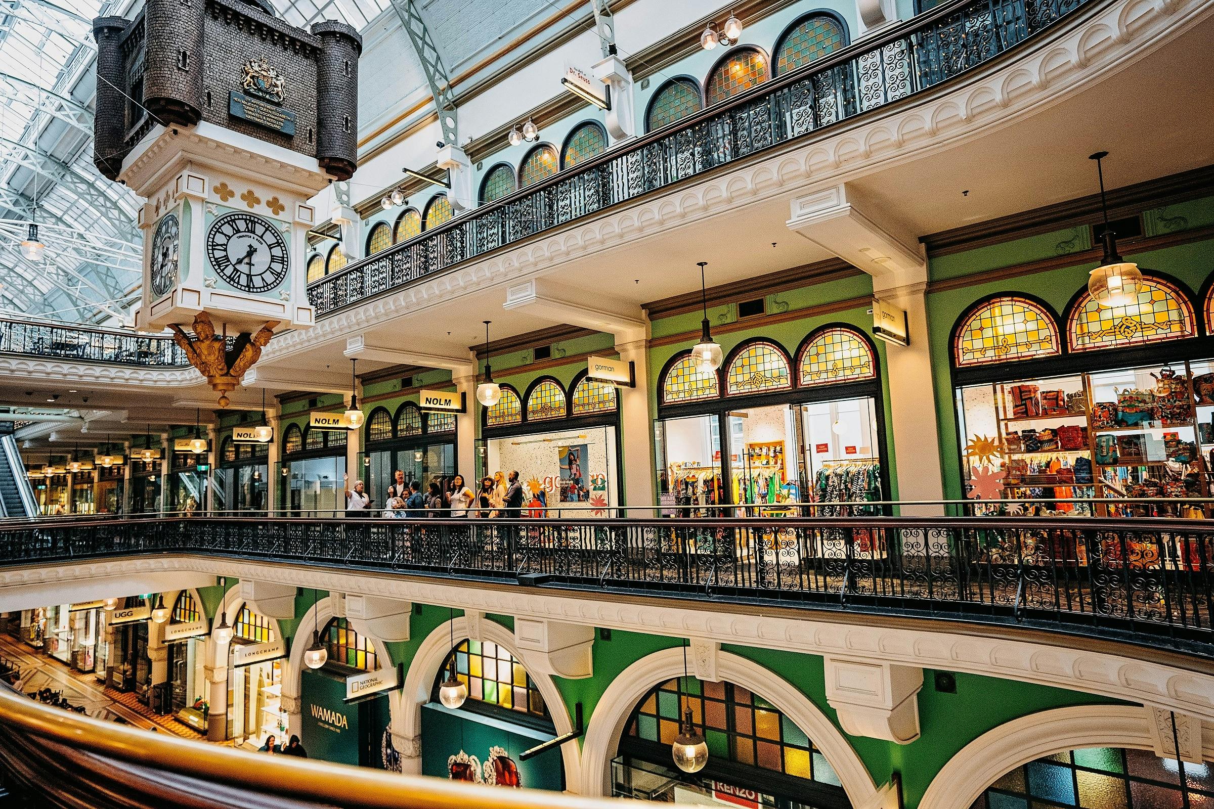 A tour group admiring the Royal Clock and historical shopfronts at the QVB