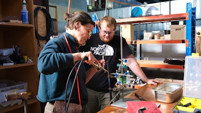 Artist bending NEON glass