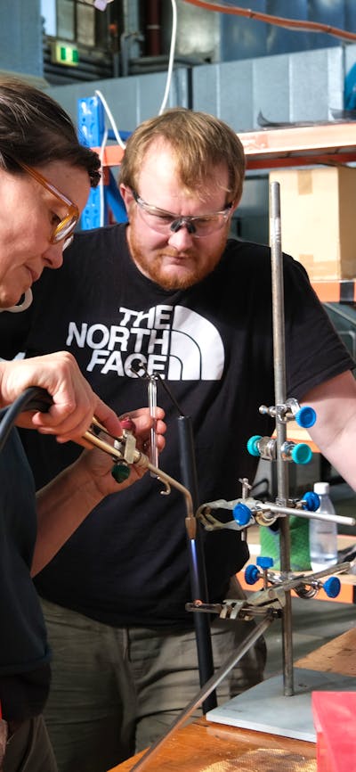 Artist bending NEON glass