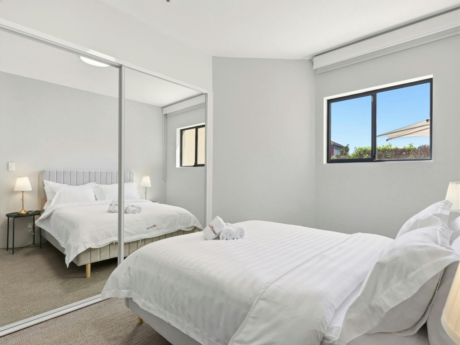 Twin bedroom with mirrored wardrobe
