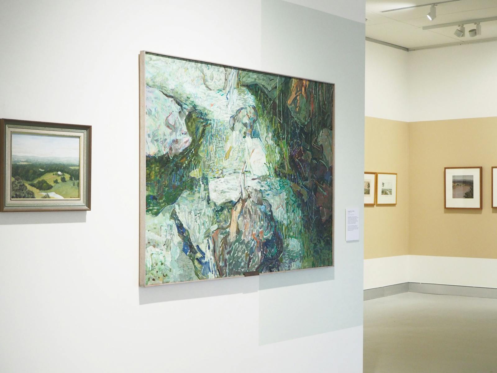 Two landscape paintings hung on a wall.