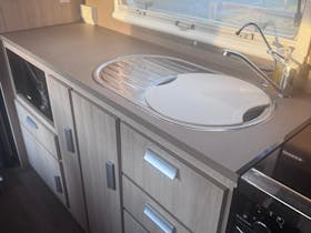 Kitchen sink with cutting board inset and cabinetry