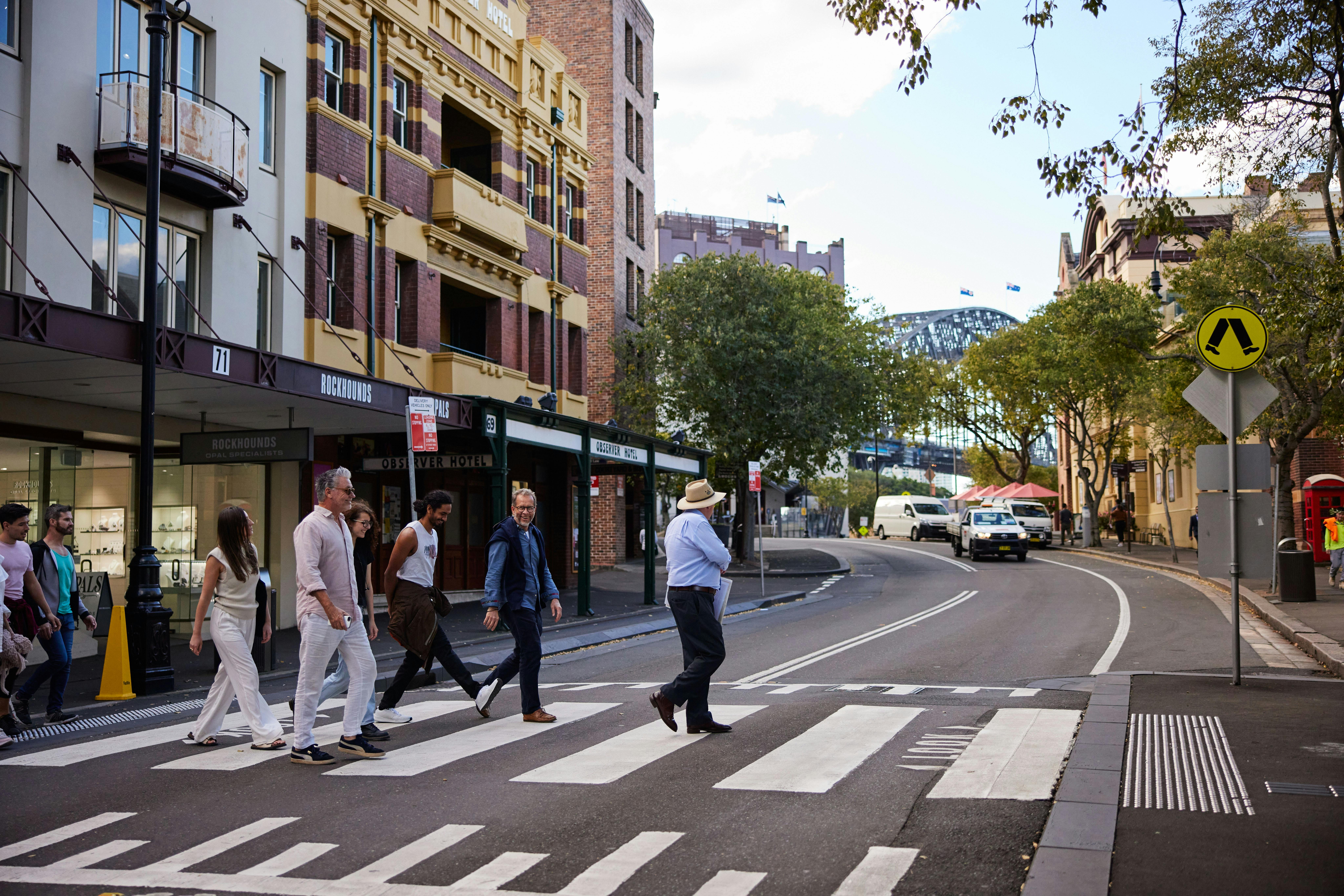 Exploring the historic streets of The Rocks on a guided walking tour, with the Sydney Harbour Bridge
