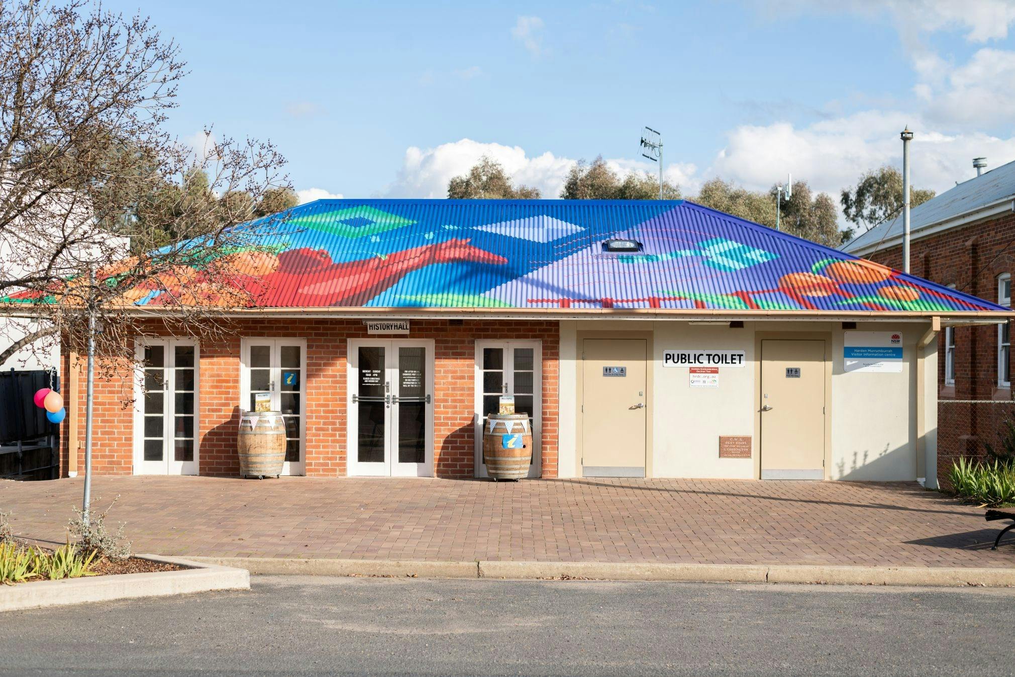 Exterior of centre with brightly coloured art patterns on roof.