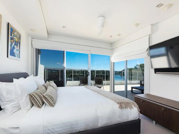 Master bedroom with TV and lake views