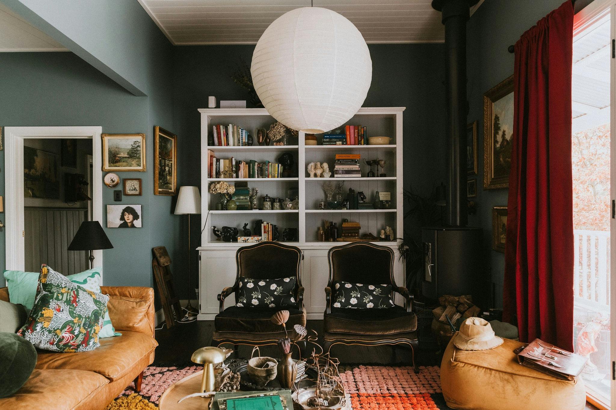 Lounge room that features bookcase and fire