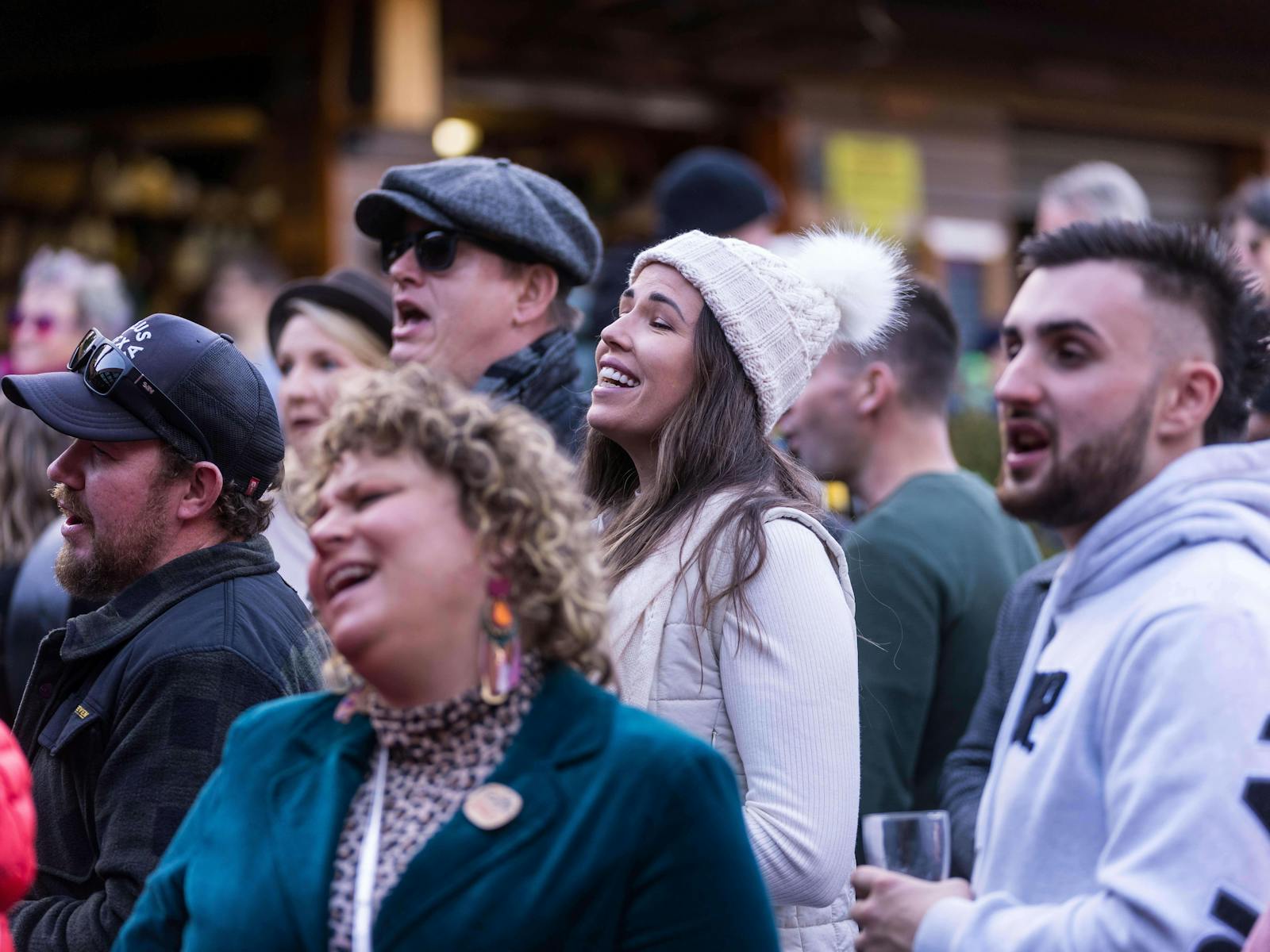 A colour photograph of different people enjoying the chance to sing together at the pub