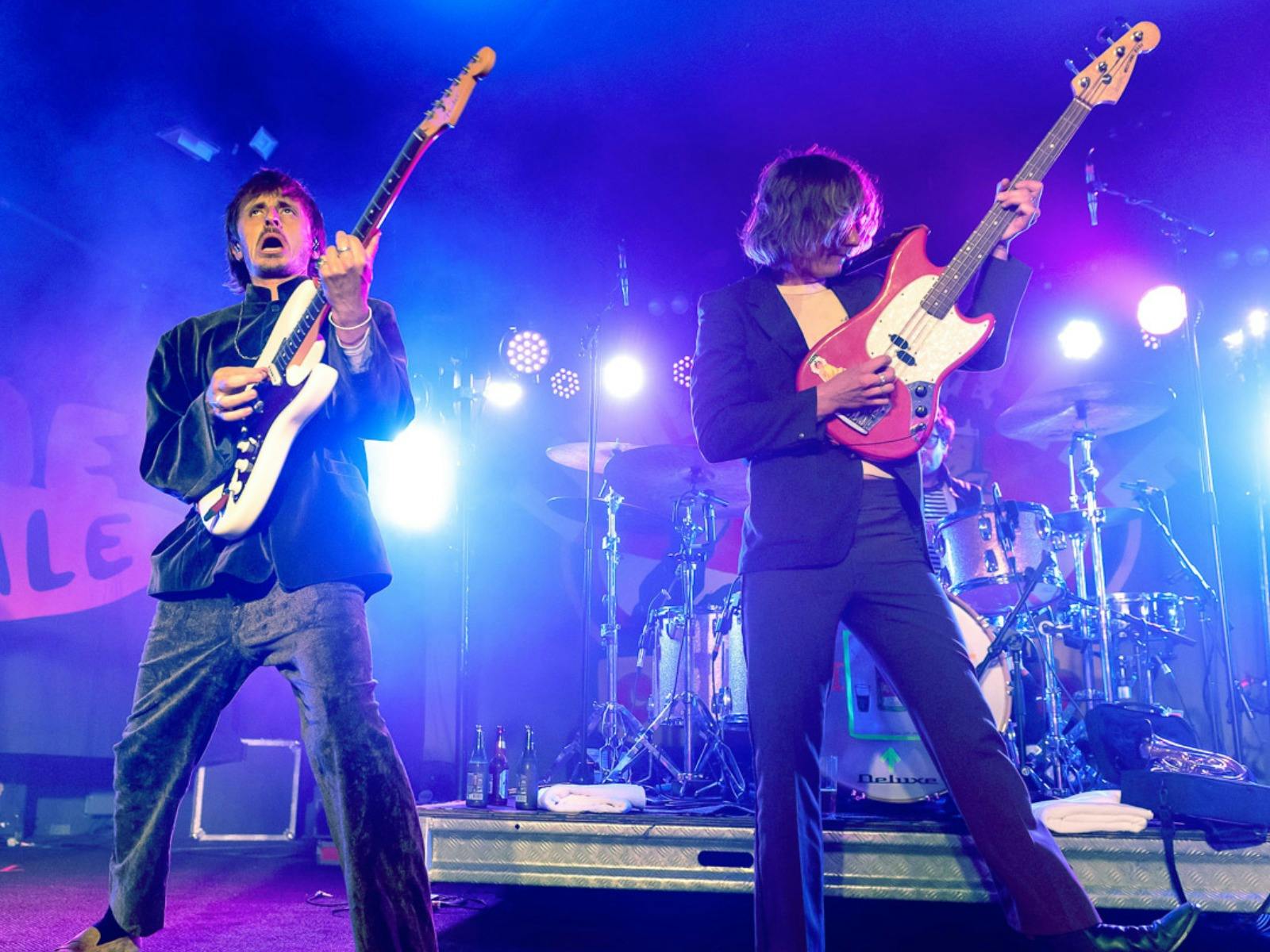 Band peforming on stage in blue lighting