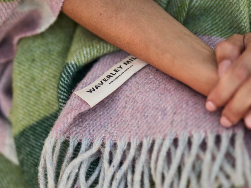 Hands crossed over Breezy Throw in Bloom