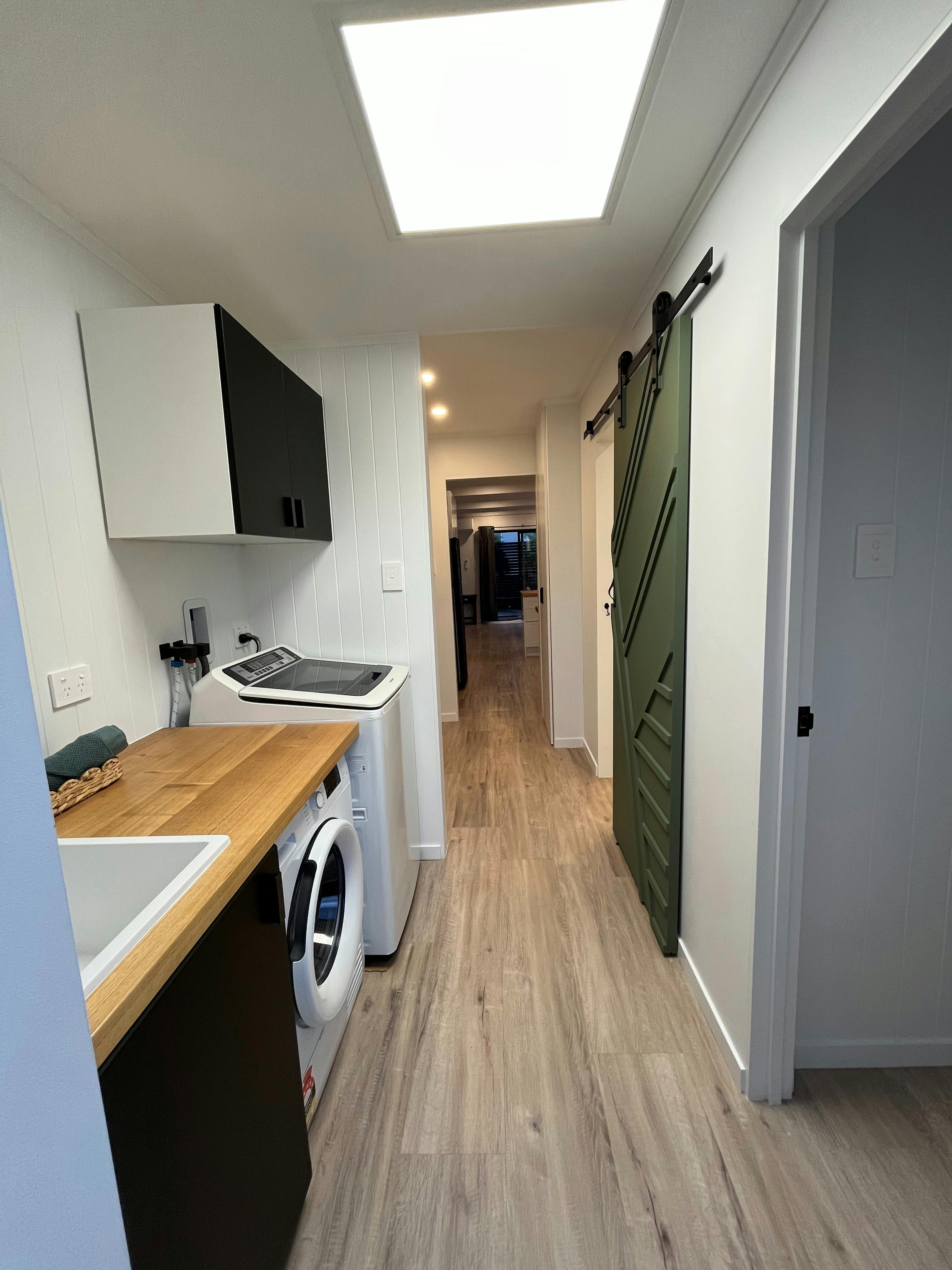 Laundry with washing machine, hp tumble dryer & basin