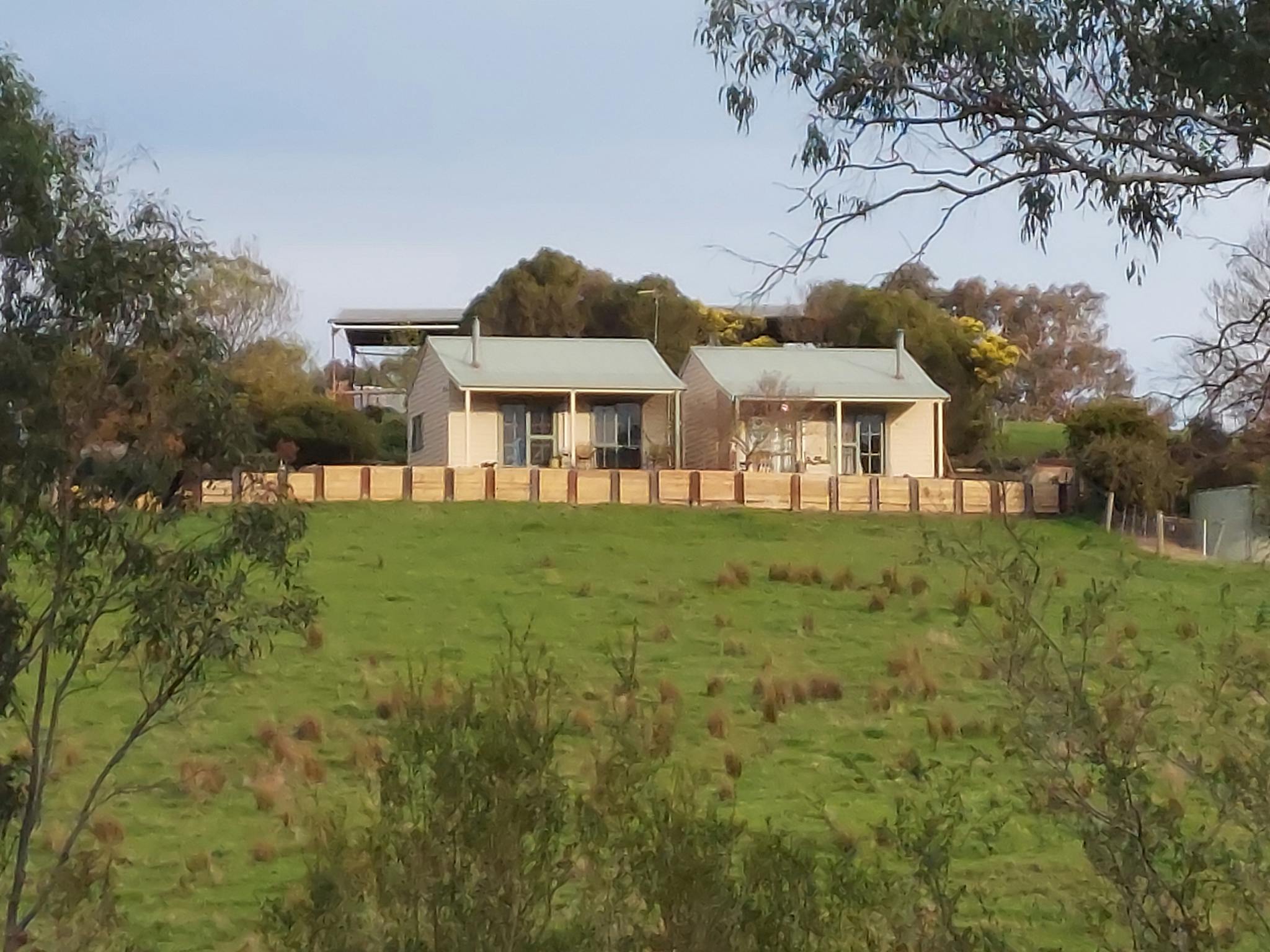The two cottages sit side by side looking out onto a serene rural view.