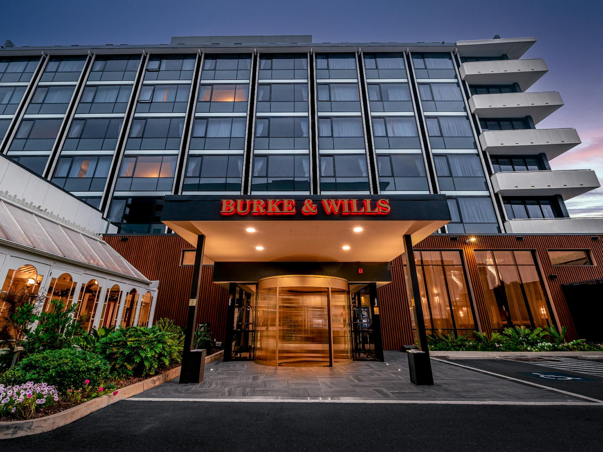 Exterior of the Burke & Wills Hotel featuring the golden revolving door to the reception entrance Exterior of the Burke & Wills Hotel featuring the golden revolving door to the reception entrance