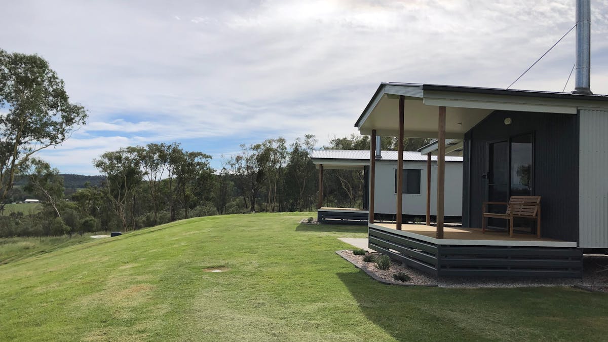 view of two cabins and surrounding