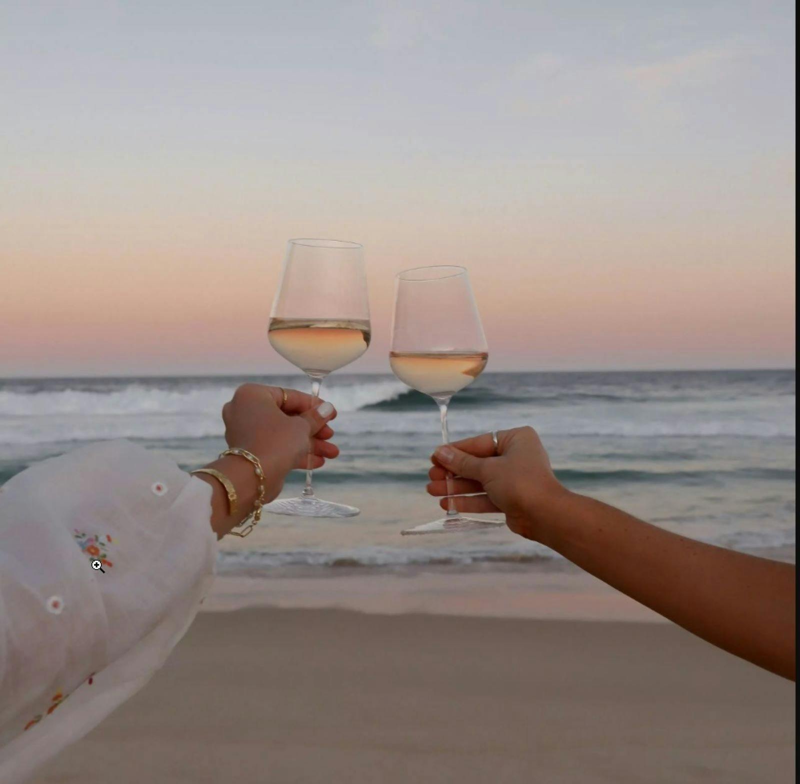 Wine glasses with beach in background