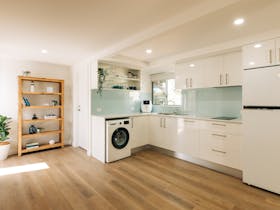 Downstairs kitchenette contains an induction hot plate, airfryer, toaster, fridge & washing machine.